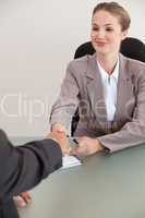 Portrait of a young manager shaking the hand of a customer