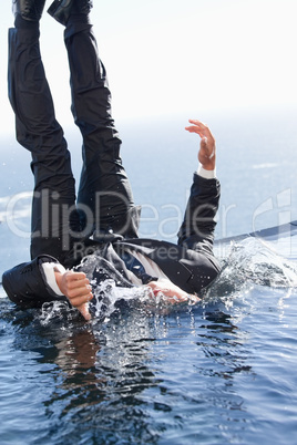 Portrait of a cheerful businessman falling into water