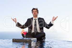 Businessman relaxing in the lotus position