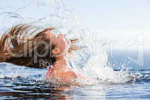Beautiful woman raising her head out of the water