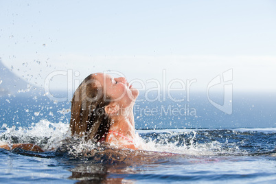 Gorgeous woman raising her head out of the water