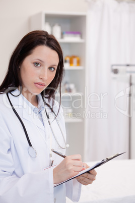 Female doctor writing on her notepad