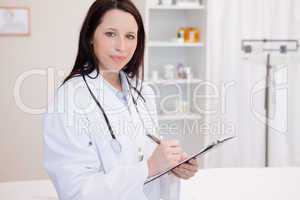 Female physician taking notes