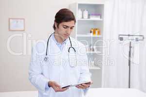 Male doctor working on tablet