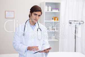 Male doctor using tablet