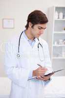 Male doctor taking notes