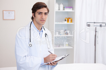 Male doctor with clipboard and pen