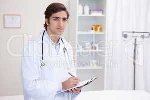 Male doctor with clipboard and pen