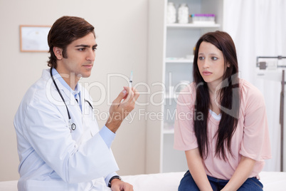 Doctor preparing injection for patient