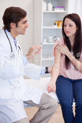 Male doctor about to give an injection to patient
