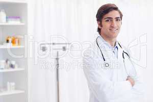 Smiling doctor standing in examination room
