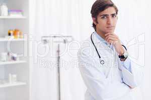 Male doctor standing in examination room