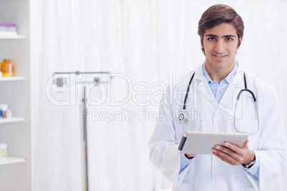 Smiling doctor with tablet