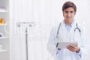 Smiling doctor with tablet