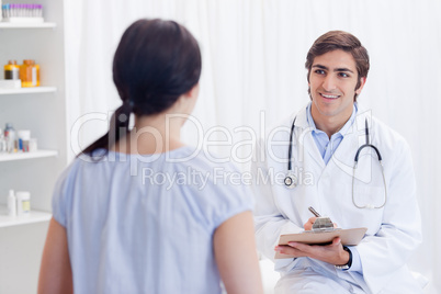 Smiling physician talking with patient