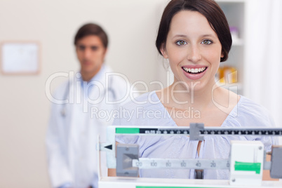 Smiling woman on the scale