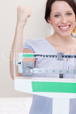 Happy smiling woman on the scale