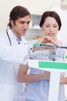 Doctor adjusting scale for his patient