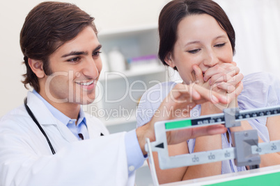 Doctor adjusting scale for excited patient