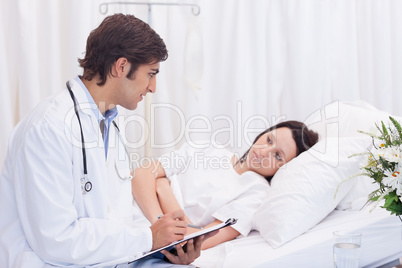 Doctor talking to his patient that just woke up