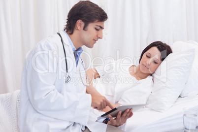 Young doctor talking to patient