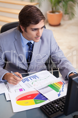 Businessman analyzing statistics at his desk
