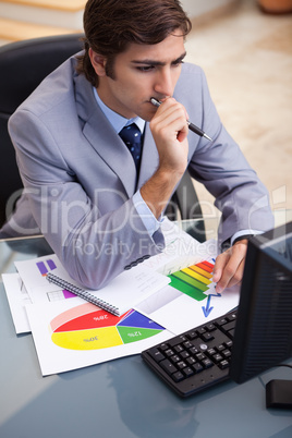 Businessman working on statistics at his desk