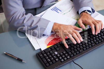 Businessman's hands typing on keyboard