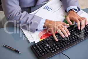 Businessman's hands typing on keyboard