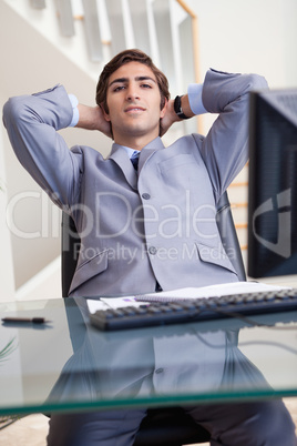 Businessman leaning back in his office
