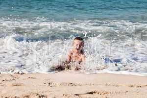 Child boy on sea beach