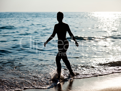 Woman silhouette on sea beach