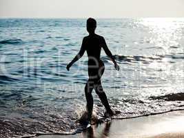 Woman silhouette on sea beach