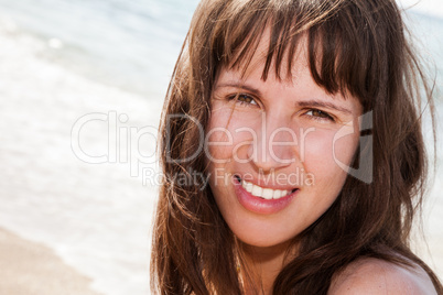 Smiling woman on sea beach