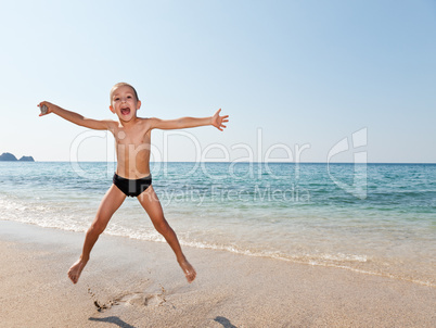 Child boy on sea beach