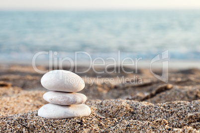 Stack or pile of balancing stones on sea beach