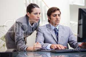 Business team looking at computer screen together