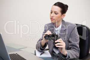 Businesswoman with binoculars on her desk