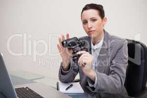 Businesswoman on her desk with binoculars