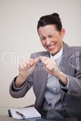 Angry businesswoman breaking pencil