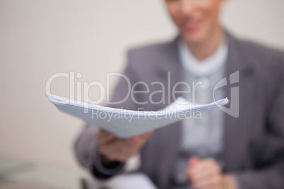 Paperwork being handed over by businesswoman