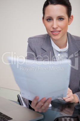 Businesswoman handing over paperwork