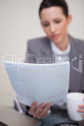 Contract being read by businesswoman