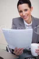 Smiling businesswoman holding contract