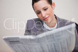 Businesswoman reading newspaper