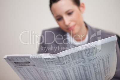 Newspaper being read by businesswoman