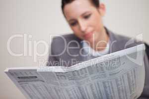 Newspaper being read by businesswoman