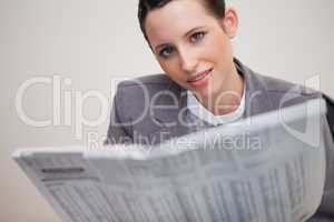 Businesswoman with newspaper