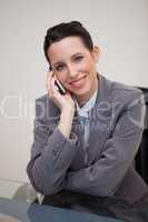 Smiling businesswoman having a call on her cellphone
