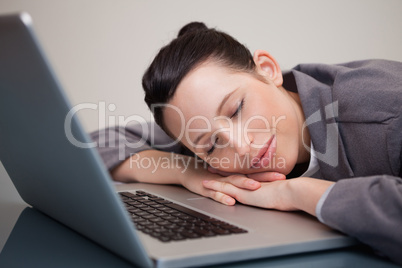 Businesswoman taking a small nap on her laptop